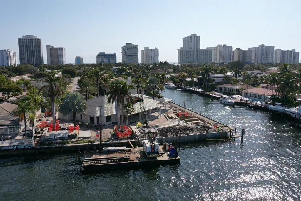 Beautiful waterfront view of 31 Fort Royal Isle in Ft. Lauderdale with lush greenery and clear blue skies.
