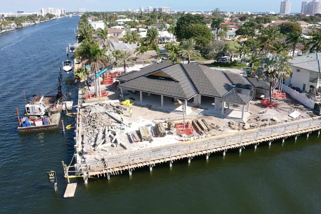 Luxurious waterfront property at 31 Fort Royal Isle, featuring a modern design and lush landscaping.