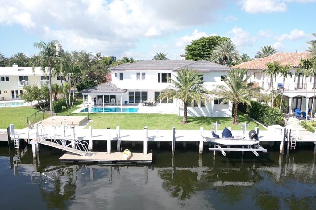 Exterior view of 33 Isla Bahia Dr. 2, showcasing modern architecture and landscaping in a sunny setting.