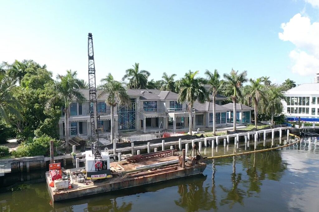 5 Isla Bahia Terr 1 features a modern home with a well-manicured lawn and vibrant landscaping.