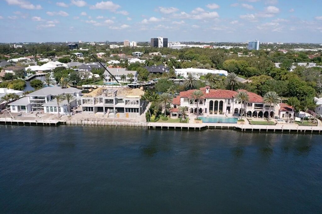 A modern residential building named Compass Intercoastal Side 2, showcasing sleek architecture and coastal views.