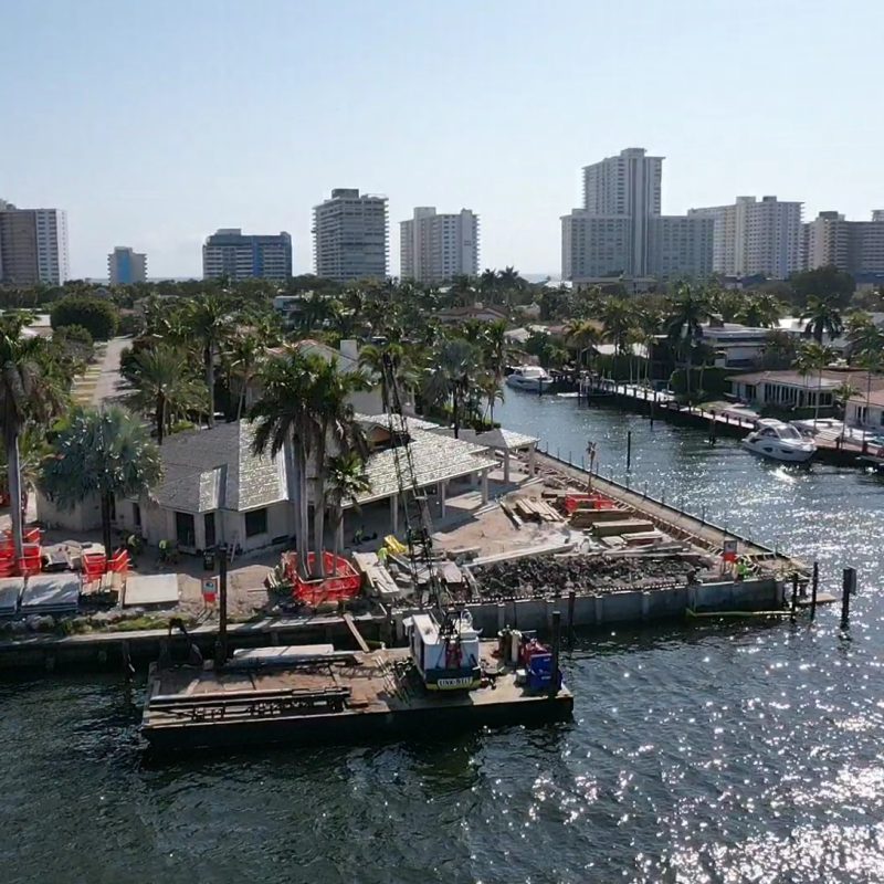 Beautiful waterfront view of 31 Fort Royal Isle in Ft. Lauderdale with lush greenery and clear blue skies.