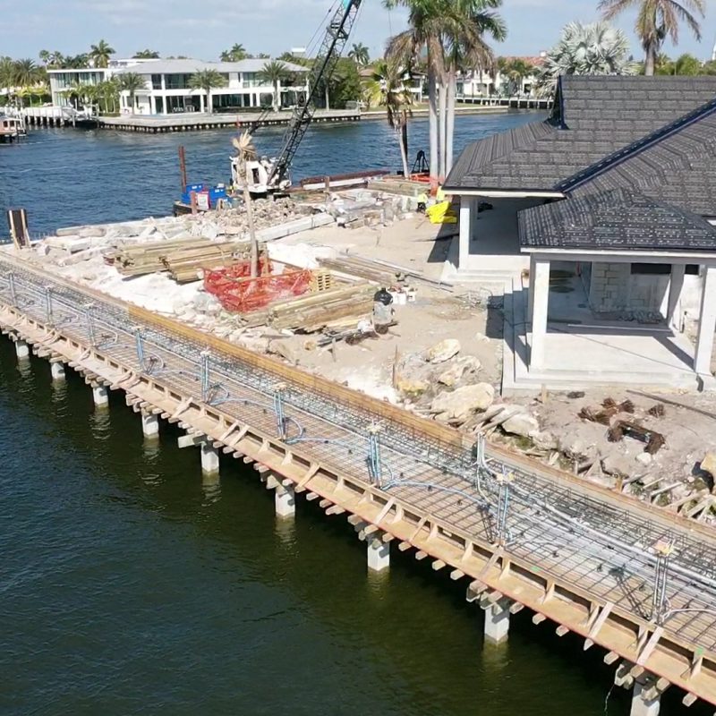 A beautiful waterfront view of 31 Fort Royal Isle, showcasing the luxurious home and surrounding landscape.