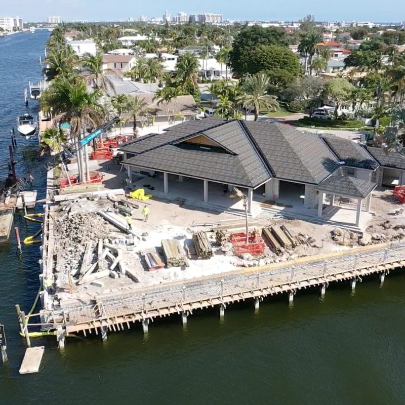 Luxurious waterfront property at 31 Fort Royal Isle, featuring a modern design and lush landscaping.