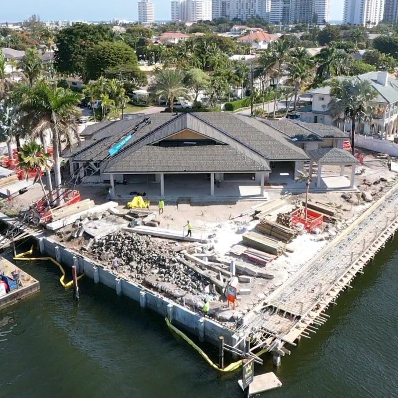 A stunning view of the waterfront property at 31 Fort Royal Isle, showcasing lush landscaping and a serene atmosphere.
