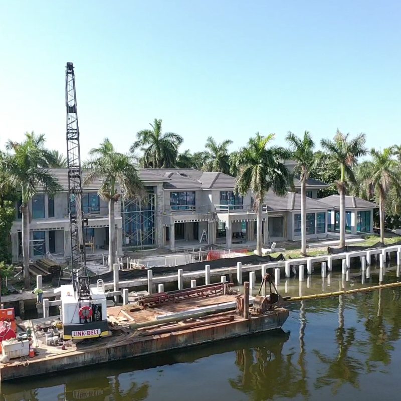 5 Isla Bahia Terr 1 features a modern home with a well-manicured lawn and vibrant landscaping.