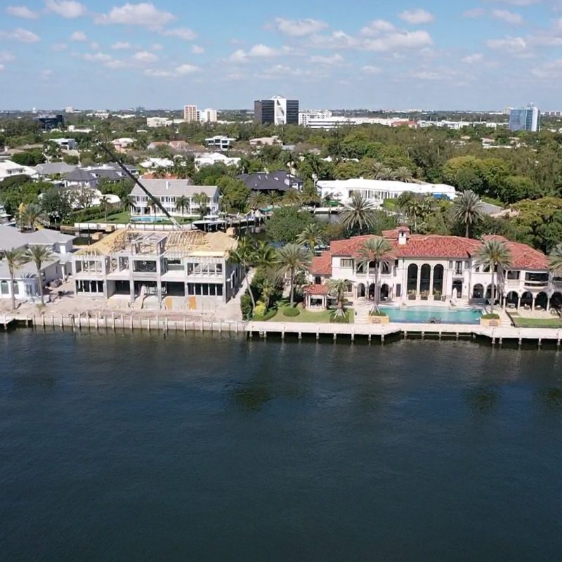 A modern residential building named Compass Intercoastal Side 2, showcasing sleek architecture and coastal views.